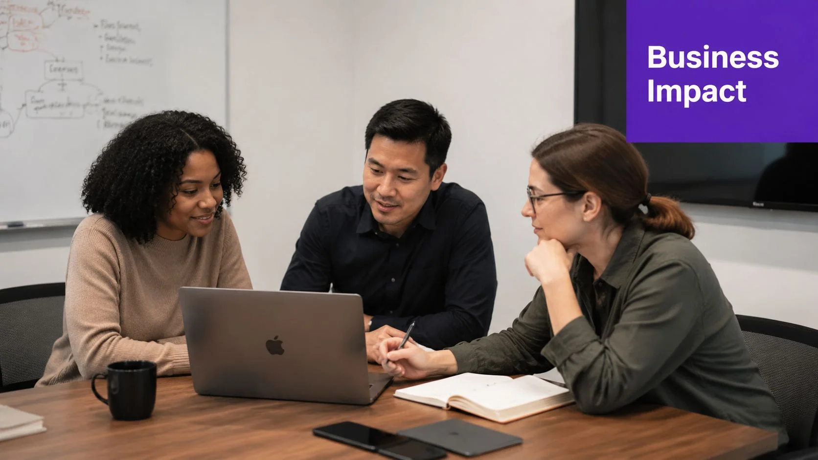 A diverse team of professionals collaborating on a project using a laptop in a modern office meeting room.